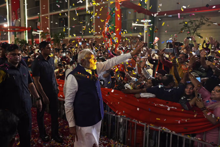 Narendra Modi greets supporters in New Delhi