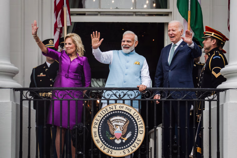 Jill Biden, Narendra Modi, and Joe Biden wave from the terrace of the White House
