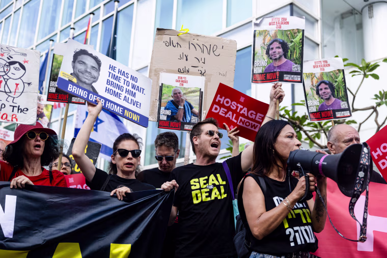 People protest holding signs calling for the return of Israeli hostages