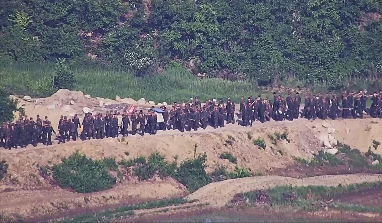 South Korean soldiers fired warning shots to repel North Korean soldiers who temporarily crossed the rivals' land border Tuesday for the second time this month, South Korea's military said.