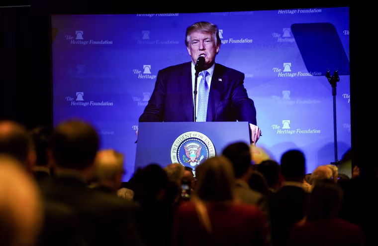 President Donald Trump is seen projected on a screen as he speaks at the Heritage Foundation's annual President's Club meeting in Washington on Oct. 17, 2017.