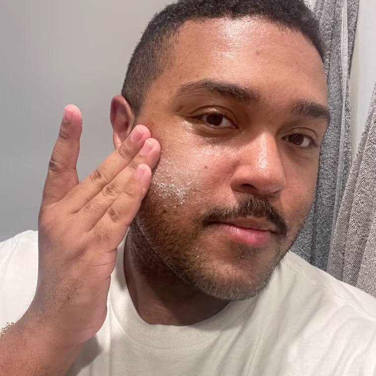 Man applies Dermalogica Daily Microfoliant Exfoliator to his face.