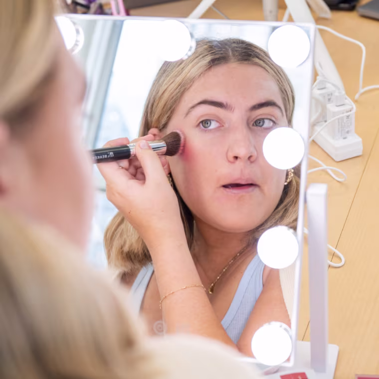 Production coordinator Camryn Privette using a lighted makeup mirror during Shop TODAY Beauty Award testing