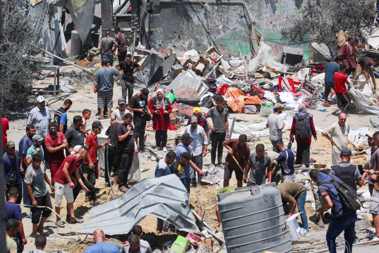 Palestinians look for loved ones in the debris of tents and make shift homes.