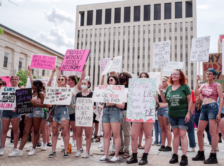 Protesters hold signs at a pro abortion rights rally, in Dayton, Ohio