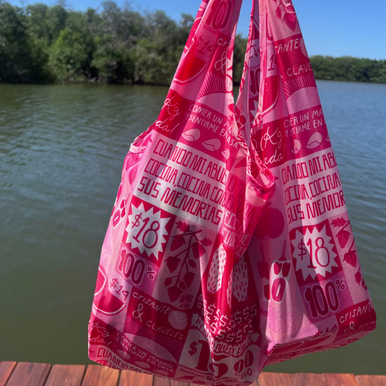 Close-up of Mili Godio on a dock with the Mercado print standard Baggu.