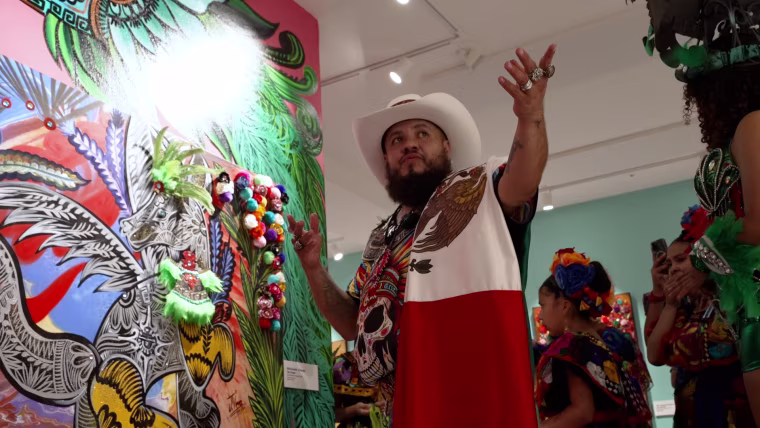 Jose Vera Gonzalez shows off one of his paintings inspired by the Parthenon's collection of pre-Columbian artifacts.