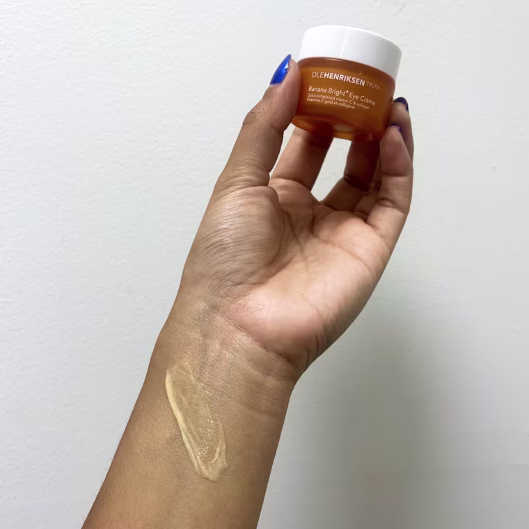 Woman swatching eye cream on her wrist