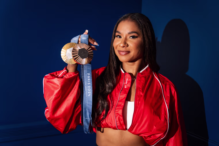 Jordan Chiles poses for a portrait holding her gold and bronze Olympic medals