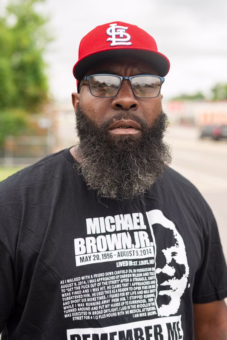 Michael Brown Sr. poses for a portrait outdoors, looking into the camera