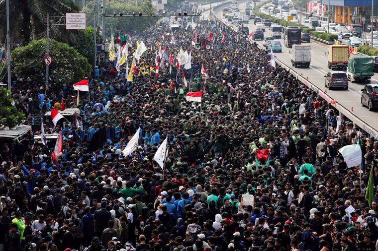 Protest against planned controversial revisions to election law outside the Parliament building in Jakarta