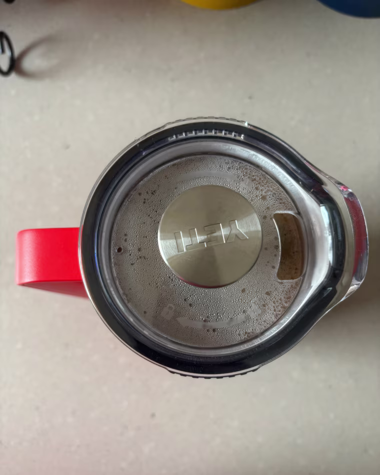 The top of the Yeti French Press lid with the plunge pushed all the way down.