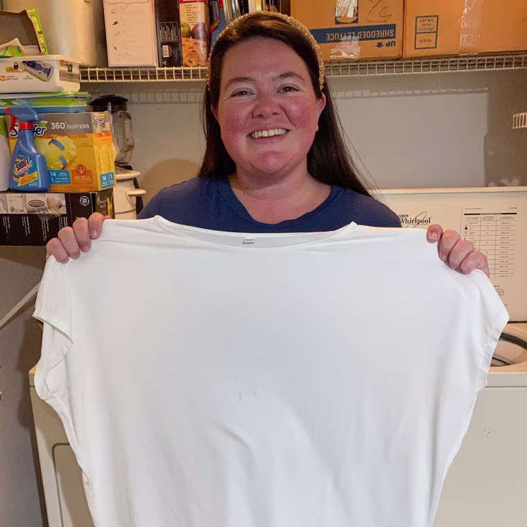 Image of Writer Megan duBois holding up a clean sheet after using Dryer Balls