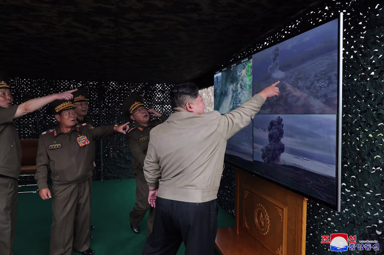 This picture taken on September 18, 2024 and released from North Korea's official Korean Central News Agency (KCNA) via KNS on September 19, 2024 shows North Korea's leader Kim Jong Un (R) inspecting the test firing of a new tactical ballistic missile, at an undisclosed location in North Korea.