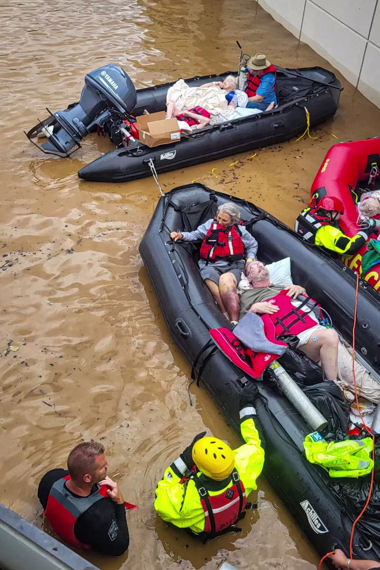 People evacuate Unicoi County Hospital due to unusually high and rising water from the Nolichucky River.
