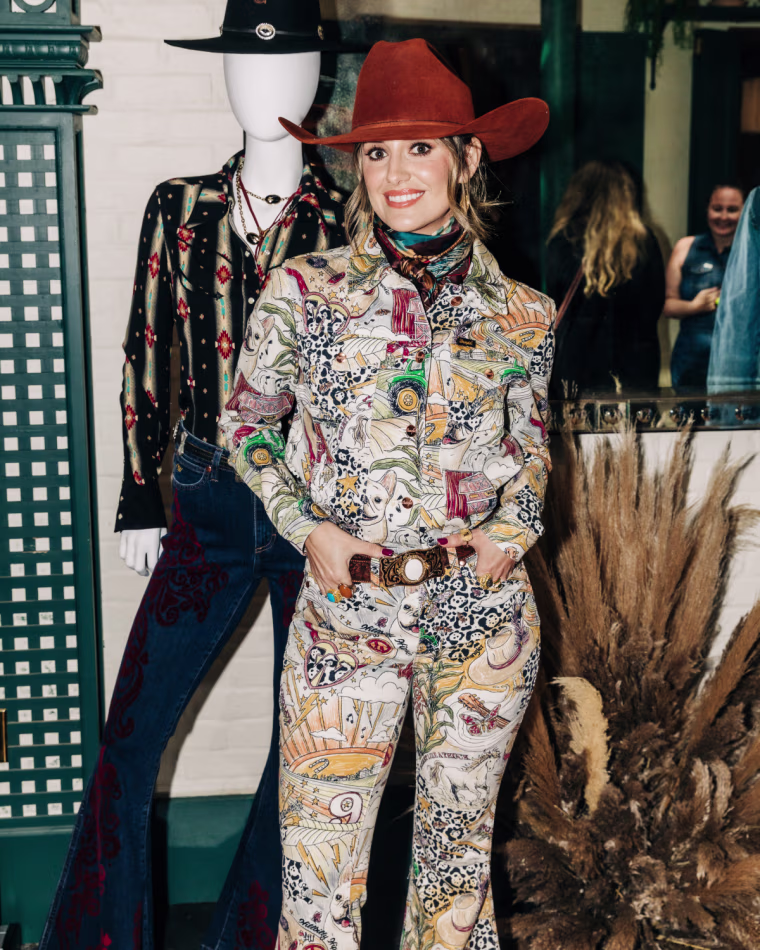 Lainey Wilson wearing the Life of Lainey Trucker Storyteller Print.