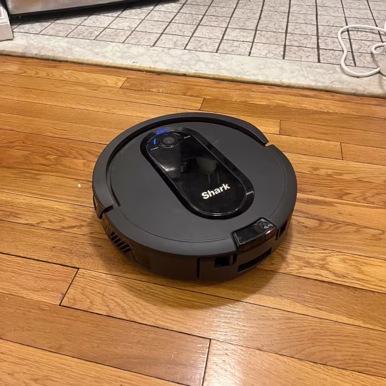 Shark robot vacuum on hardwood floor