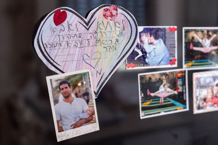 Photos on the fridge of Avital Dekel-Chen, the wife of the American Israeli hostage Sagui Dekel-Chen.