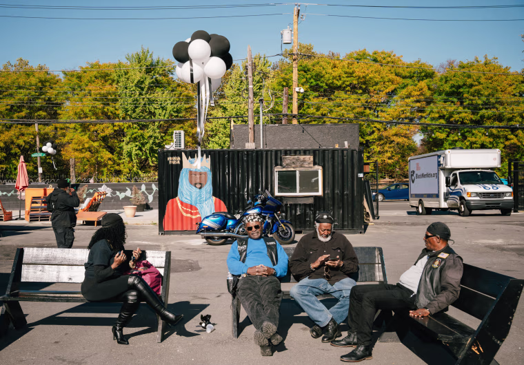 Participants are sitting at Container Village during the rally.