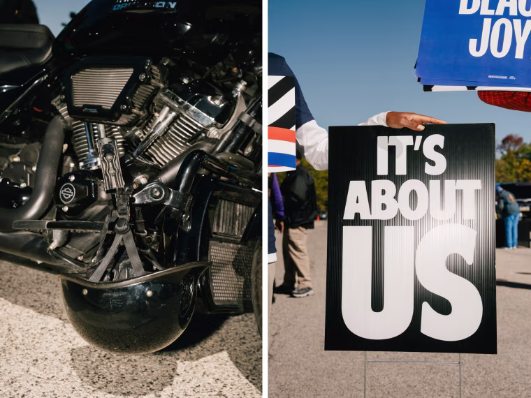 Details of a motorbike and a signs reading "Black Joy" and "It's About Us" at the bike rally.