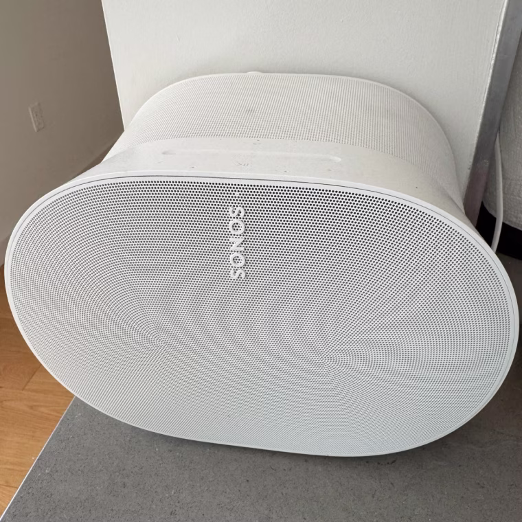The Sonos Era 300 on top of a gray counter.