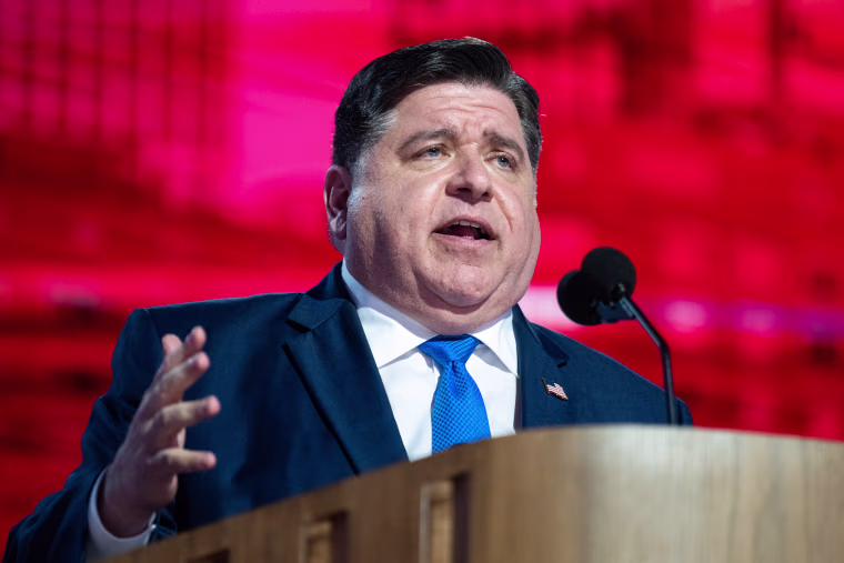 JB Pritzker speaks behind a podium