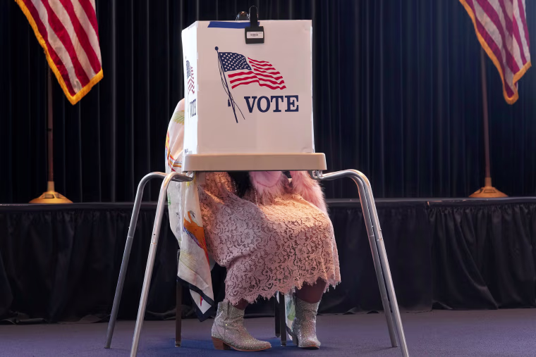 A voter works on her ballot at a polling place at the Ronald Reagan Presidential Library on Election Day, in Simi Valley, Calif., on Nov. 5, 2024.