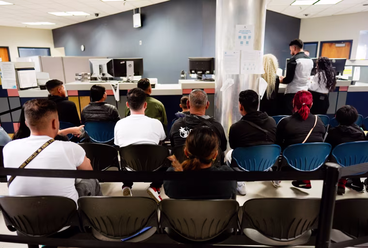 Migrants wait in a processing center at the U.S. Customs and Border Protection Dennis DeConcini port of entry in Nogales Ariz. in June.