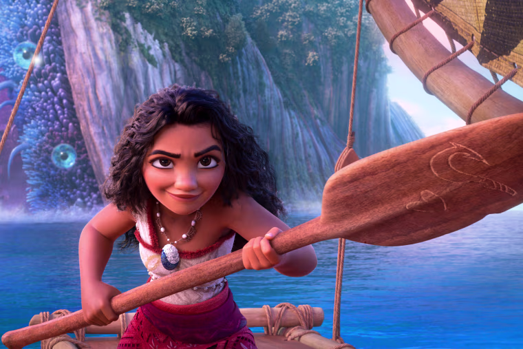 Moana holds an ore on a boat in the water