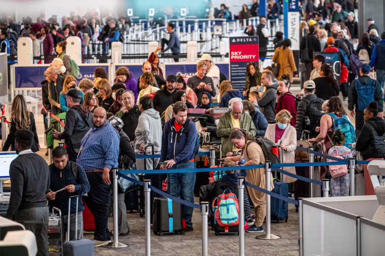 Travelers wait in line at San Francisco International Airport.