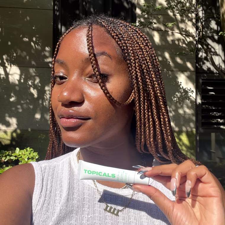 Woman holding lip balm after applying it on her lips