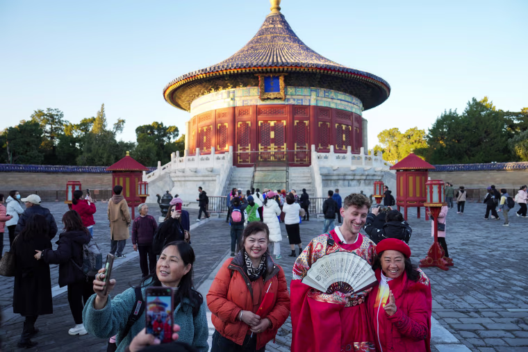 Tourists pose for photos at Heaven Park in Beijing on Nov. 21, 2024.