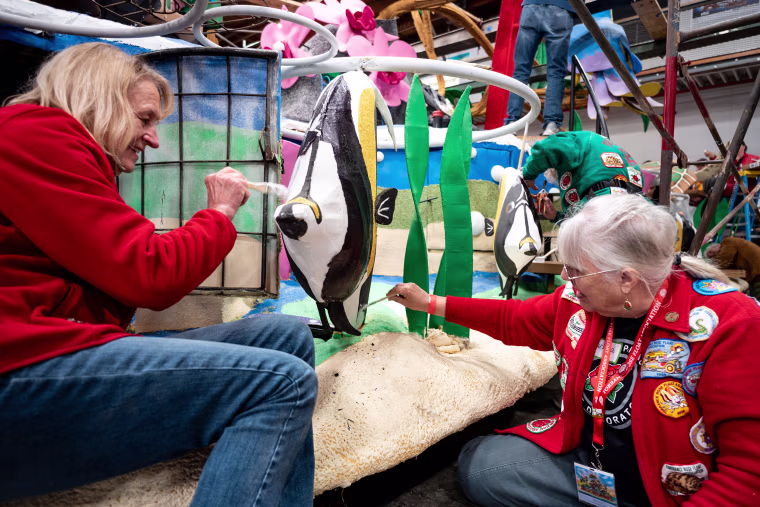 Volunteers prepare floats for the 136th annual Rose Parade