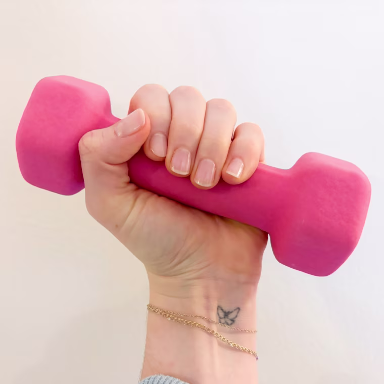 Woman holding pink 3-pound dumbbell