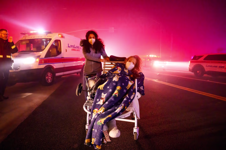 A ferocious wildfire in a Los Angeles suburb devoured buildings and sparked panicked evacuations January 7, as hurricane-force winds tore through the region.
