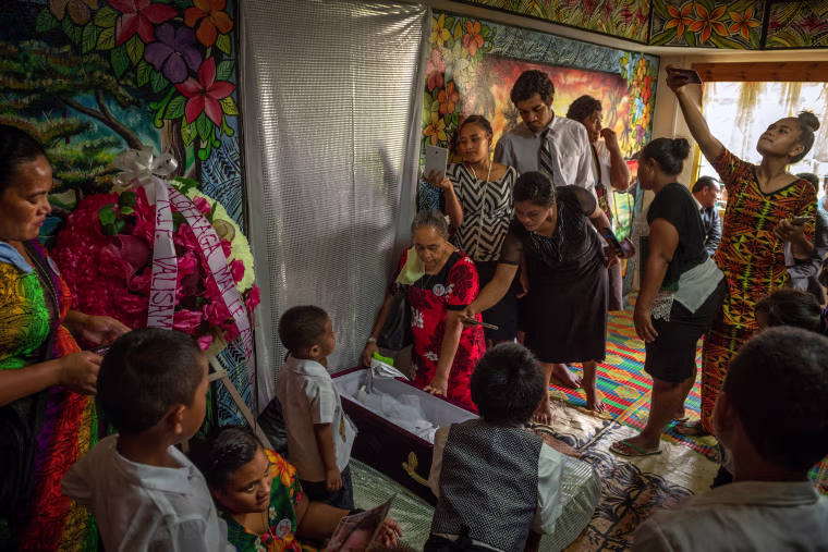 Funeral for a child who died after contracting measles, in Faleasiu, Samoa.