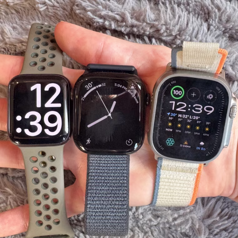 A close up image of the Apple Watch Series 10, Apple Watch SE and Apple Watch Ultra 2 in the writer’s hand.