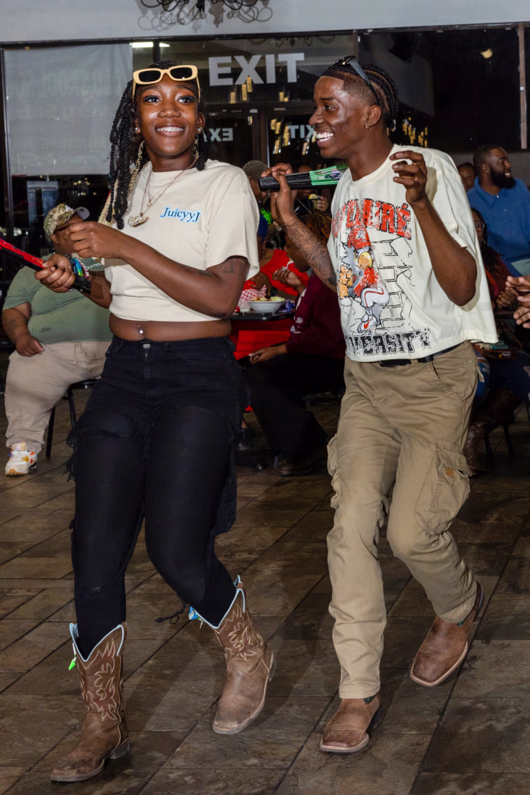 Ja’Mai Richardson, left, and Quinton Dais perform a line dance