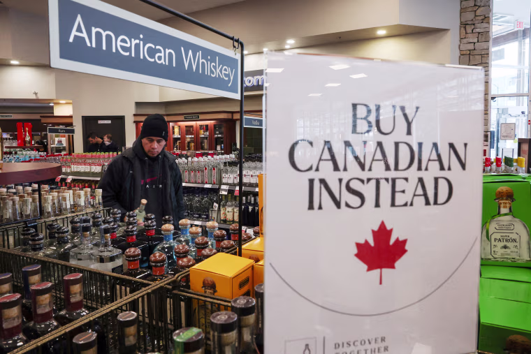 Empty shelves remain with signs ''Buy Canadian Instead'' after the top five U.S. liquor brands were removed from sale at a B.C. Liquor Store, in Vancouver