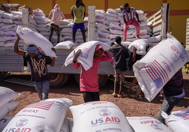 Volunteers at a displacement camp unload an aid delivery from USAID on Dec. 17, 2021 in Bahir Dar, Ethiopia.