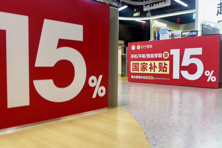 Banners at an electronics retailer in Beijing advertising government subsidies on smartphones and other devices to boost consumer spending.