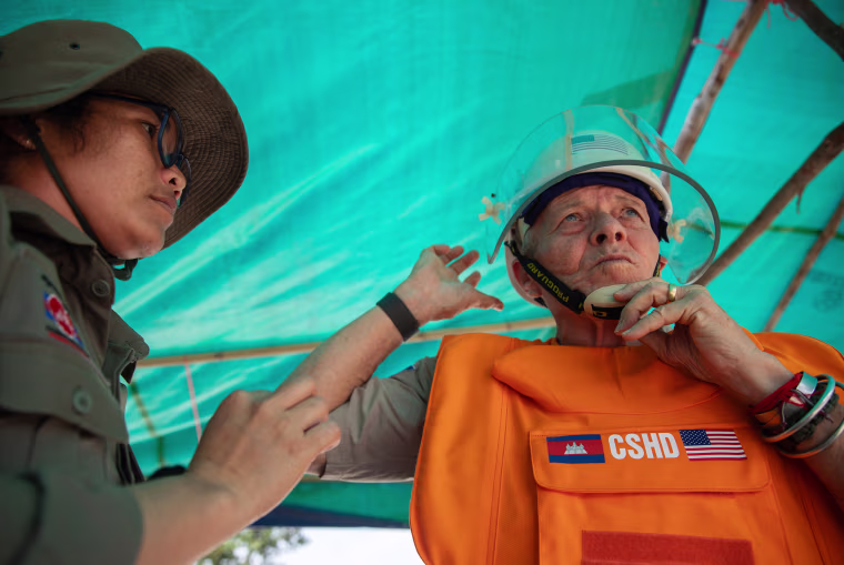 Bill Morse puts on personal protective equipment before entering a landmine field in Siem Reap.