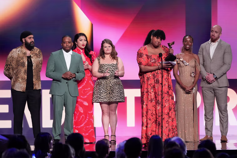 Arkie Kandola, from left, Chris Powell, Jaylee Hamidi, Michelle McLeod, Natasha Rothwell, Elle Lorraine and KeiLyn Durrel Jones accept the award for best ensemble cast in a new scripted series for "How to Die Alone" during the Film Independent Spirit Awards on Saturday.