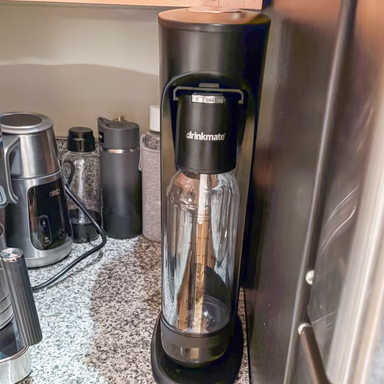 Drinkmate Omnifizz soda maker sitting on a countertop.