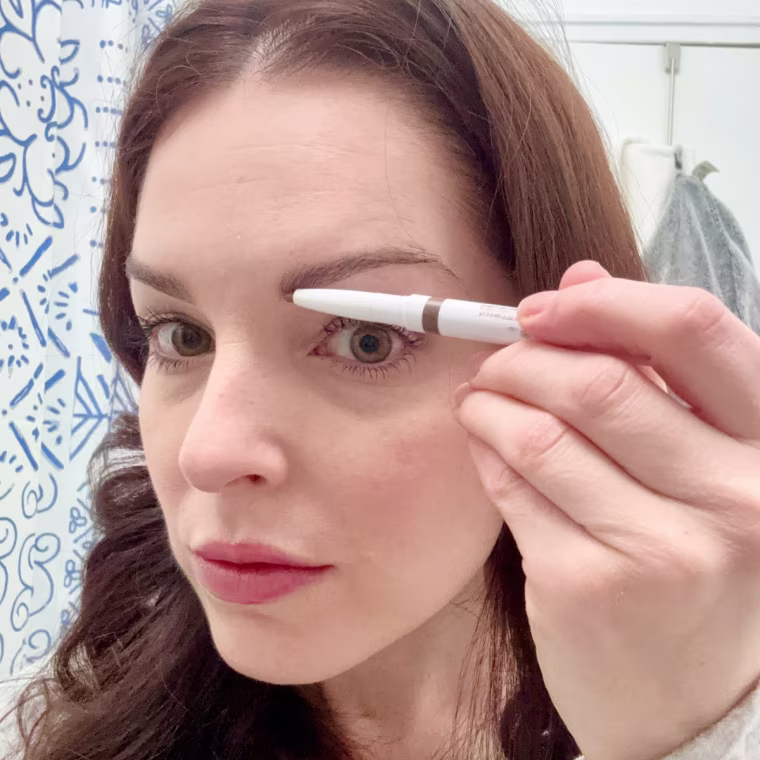 Associate editor Shannon Garlin applying e.l.f. Instant Lift Brow Pencil in neutral brown.