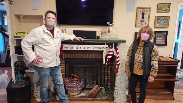 Andrea-Marie Stark and her husband in their smoke-damaged home in Altadena.