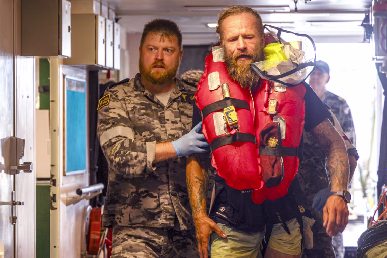 An Australian warship on Monday rescued a Lithuanian solo rower who had encountered a tropical cyclone while attempting to cross the Pacific Ocean from California.