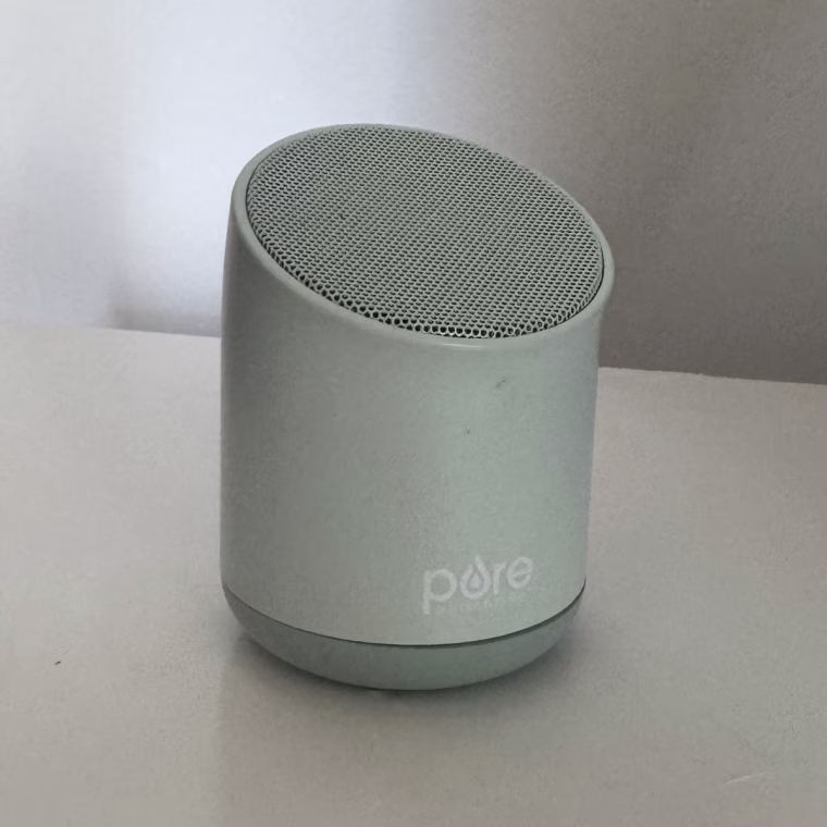 Pure Enrichment sound machine sitting on a table.