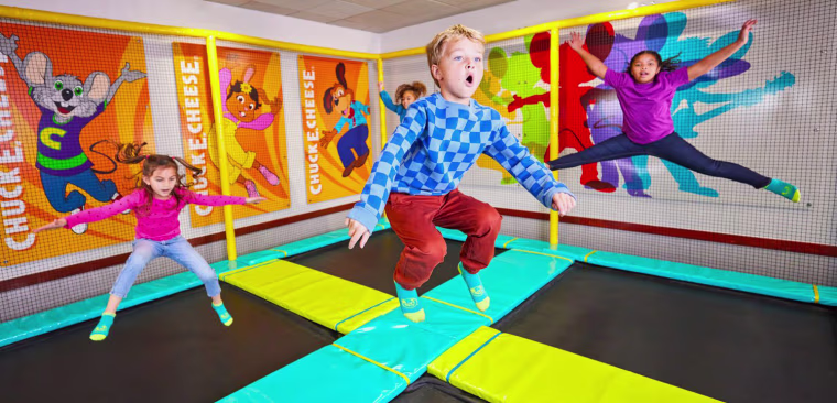 Children jump on a trampoline at Chuck E. Cheese.