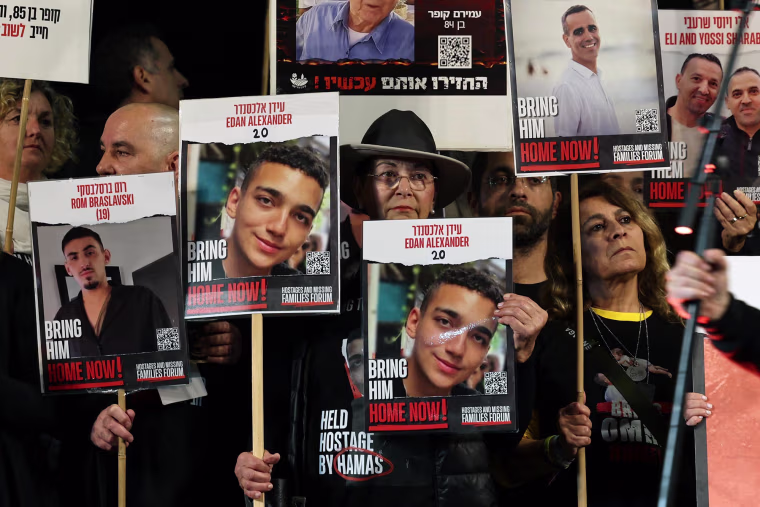 Relatives and supporters hold placards of Israeli hostages, including Edan Alexander, in Tel Aviv on Dec. 30, 2023. 